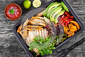 Chicken Fajita Platter with Avocado, Pita Bread, Bell Pepper, Lime, Red Onion and Cilantro, bowl with salsa sauce, clos