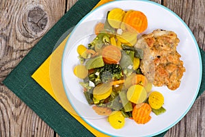 Chicken fillet grilled with vegetable mixt on wooden background