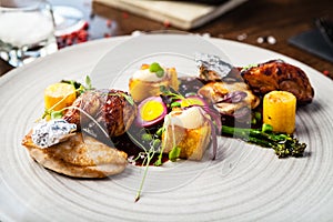 Chicken fillet, Jerusalem artichoke puree, dewberry sauce, potato, quail egg. Delicious healthy traditional food closeup