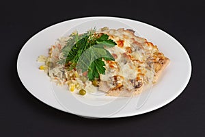 Chicken fillet with mushrooms and cheese garnished with rice, corn and peas