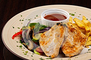 Chicken fillet with vegetables and French fries