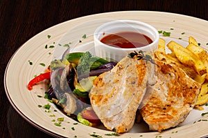 Chicken fillet with vegetables and French fries photo