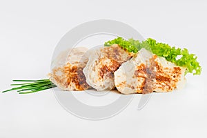 Chicken fillets fried until half cooked, semi-finished product with fresh herbs on a white background. Fast food. Quick