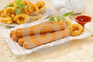 Chicken franks with potato swirls basil and ketchup with mayonnaise