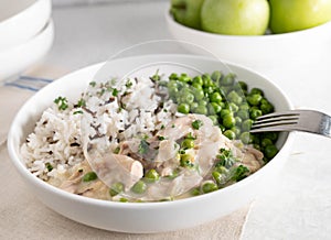 Chicken fricassee with basmati rice and wild rice. Served with buttered green peas on a plate photo