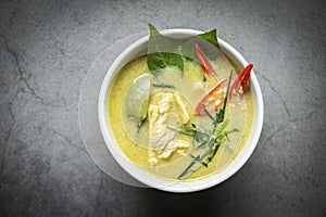 Chicken green curry Thai food on soup bowl with ingredient vegetable herbs and spices pepper chili dark background, Traditional