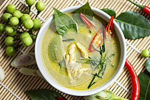 Chicken green curry Thai food on soup bowl with ingredient vegetable herbs and spices pepper chili, Traditional green curry