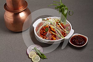 Chicken Hakka Schezwan Noodles served in a bowl with Schezwan sous . selective focus