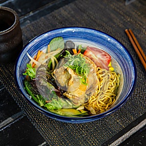 Chicken karaage cold ramen with salad in the traditional Japanese ramen restaurant