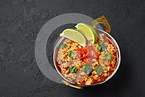 Chicken keema in traditional indian copper kadai at dark slate background