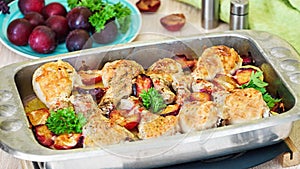 Chicken legs baked in cheese with plums and potatoes