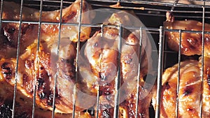 Chicken legs grilled on grill close-up outdoors