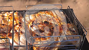 Chicken legs grilled on grill close-up outdoors