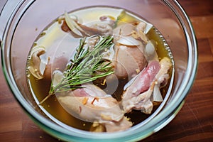 chicken legs marinating in wine and herbs for coq au vin