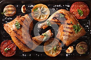 chicken legs and vegetables on grill pan closeup. Top view horizontal