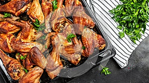Chicken legs, wings grilled, fried on oven on baking tray. Oven baked chicken pieces. Restaurant menu, dieting, cookbook recipe
