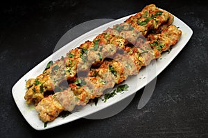 Chicken lulia kebab with herbs on a plate