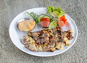 chicken malai boti tikka kabab with salad and mayonnaise dip served in dish isolated on grey background side view of indian spices