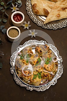 chicken malai tikka Boti seekh Kabab platter with salad in a dish top view of middle eastern barbeque dish
