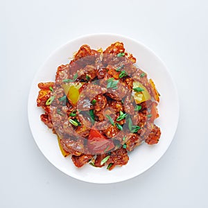 Chicken Manchurian is Indian Chinese cuisine dish with Chicken breasts, bell pepper, tomatoes, soy sauce photo