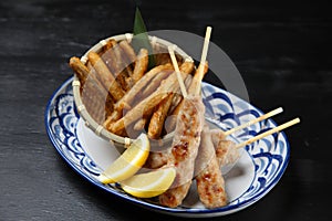 Chicken meat ball skewers with deep fried burdock