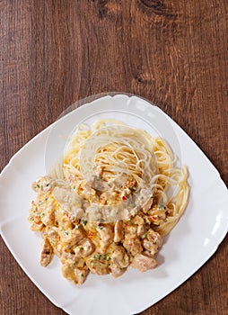 Chicken meat in a creamy sauce with spaghetti pasta