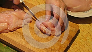 Chicken Meat Cutting. The Cook Cuts Chicken Fillet Into Pieces.