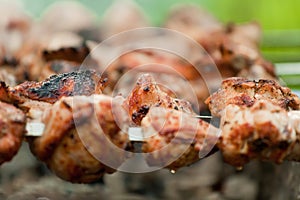 Chicken meat grilled on smouldering charcoal