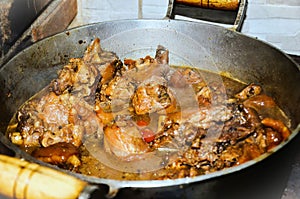 Chicken meat with pig`s feet, gallop, cooking in a wood-fired oven