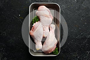 Chicken meat. Raw fresh chicken drumsticks on black slate stone background.