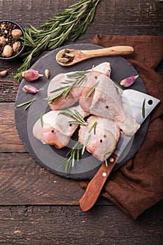 Chicken meat - Raw uncooked drumsticks or legs on slate with ingredients for cooking. Top view