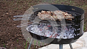 Chicken meats are grilled on charcoal barbecue.