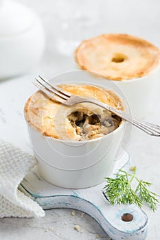 Chicken and mushrooms pot pie in white ramekin