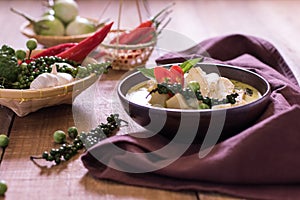 Chicken mussaman curry in bowl vegetables on wooden background