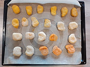 Chicken nugget different colours from different producers