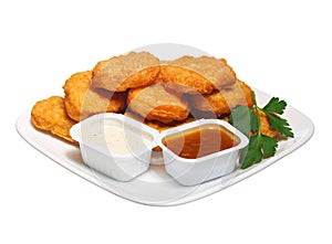 Chicken nuggets in plate with two dressings