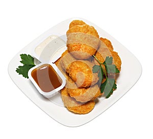 Chicken nuggets in plate with two dressings