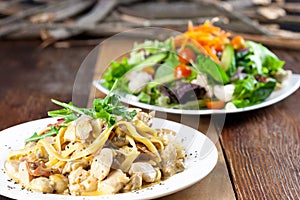 Chicken Pasta and Vegetable Salad Meal on Table