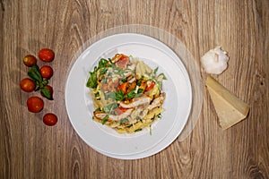 Chicken penne pasta with bread crums and veggies top view