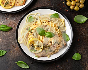 Chicken Piccata with capers, white wine sauce and spaghetti. Italian food