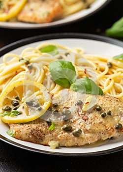 Chicken Piccata with capers, white wine sauce and spaghetti. Italian food