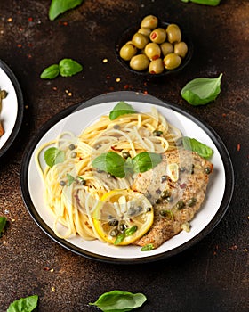 Chicken Piccata with capers, white wine sauce and spaghetti. Italian food