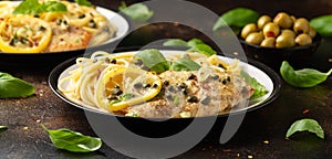 Chicken Piccata with capers, white wine sauce and spaghetti. Italian food