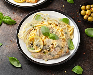 Chicken Piccata with capers, white wine sauce and spaghetti. Italian food