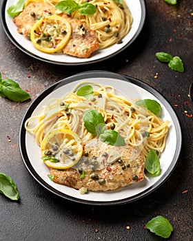 Chicken Piccata with capers, white wine sauce and spaghetti. Italian food