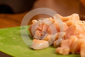 chicken pieces chopped up in a pile on a cuttingboard