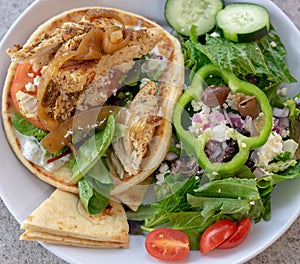 Chicken pita giro and Greek salad. Healthy eating mages. photo