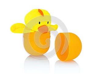 Chicken plush doll isolated on white background with shadow reflection. Yellow chick getting / breaking out of its shell.