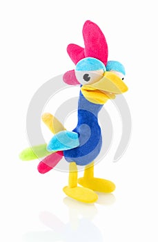 Chicken plushie doll isolated on white background with shadow reflection. Rainbow colored stuffed bird.