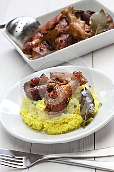 Chicken and pork adobo over yellow rice, filipino food